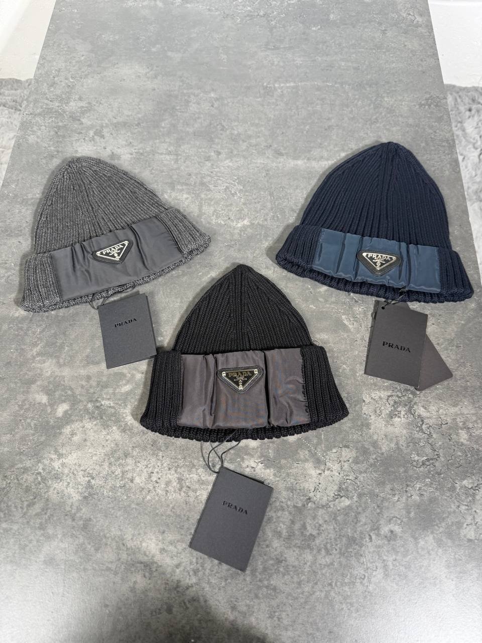 photo_5848443541355434707_y (1) Prada Re-Nylon Triangle Logo Ribbed Beanie - Image 1